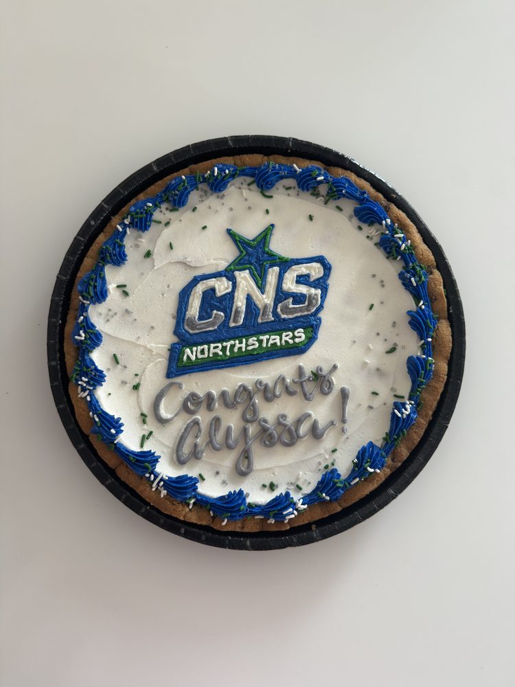 A graduation cookie cake iced with a high school team crest