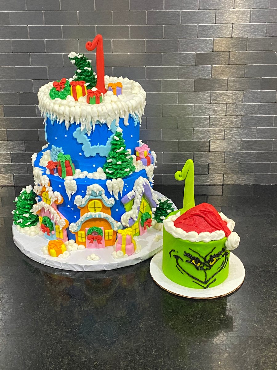 A bright first birthday cake with a smash cake