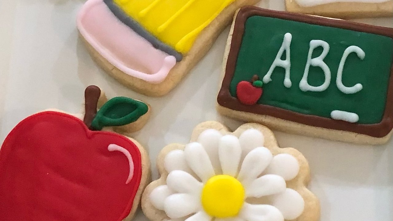 Hand-decorated sugar cookies for back to school: an apple, a pencil, a chalkboard and a daisy