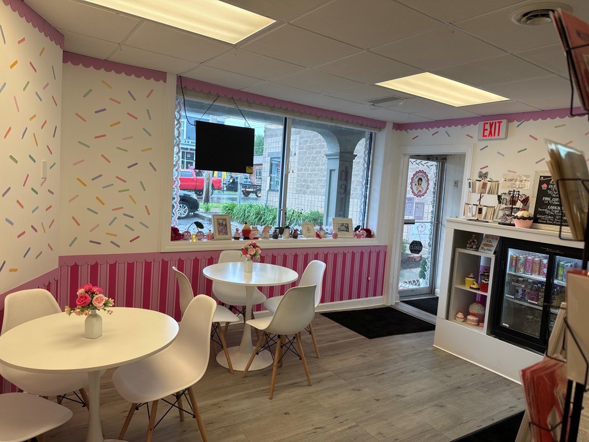 The pink interior of Mrs. Kelder's Cakes with the cupcake case and sprinkle wall