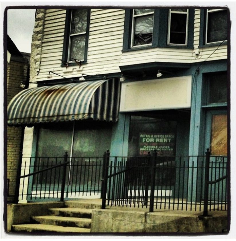 The empty storefront on East Seneca Street in 2012, with a For Rent sign in the window