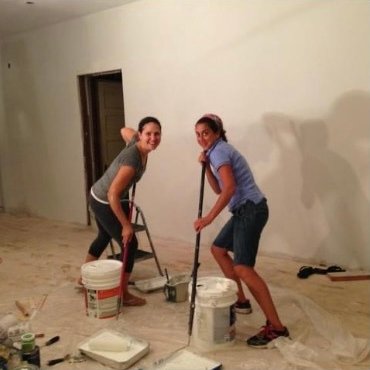 Friends painting the walls of the first shop in August 2013