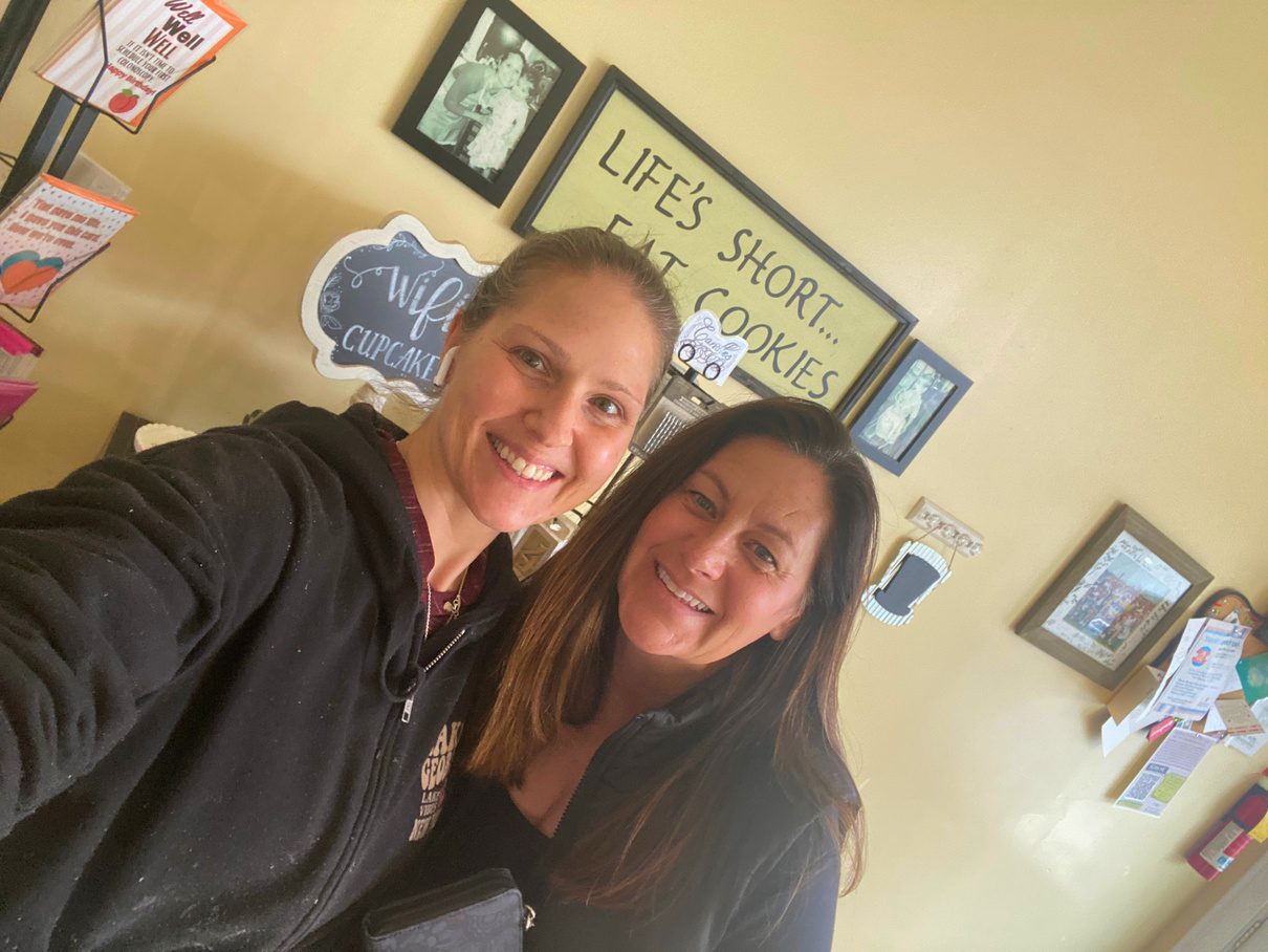 Mrs. Kelder and a friend taking a selfie in the shop